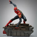 Spider-Man Integrated Suit PVC statue in a crouching wall-crawler pose on a riveted metal and wooden debris base